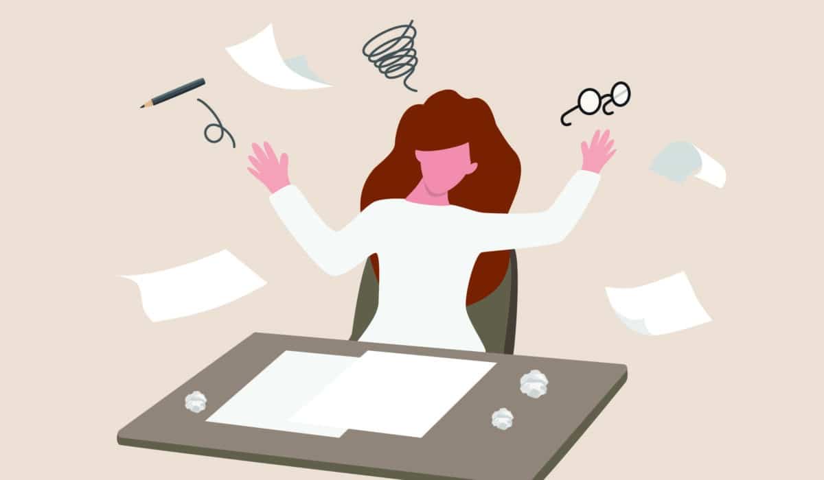On a beige background is an illustration of a person with long hair demonstrating stressed or anxiety from overload work, fatigue, burnout. The character has their hands in the air, throwing various office items around in a haphazard manner.