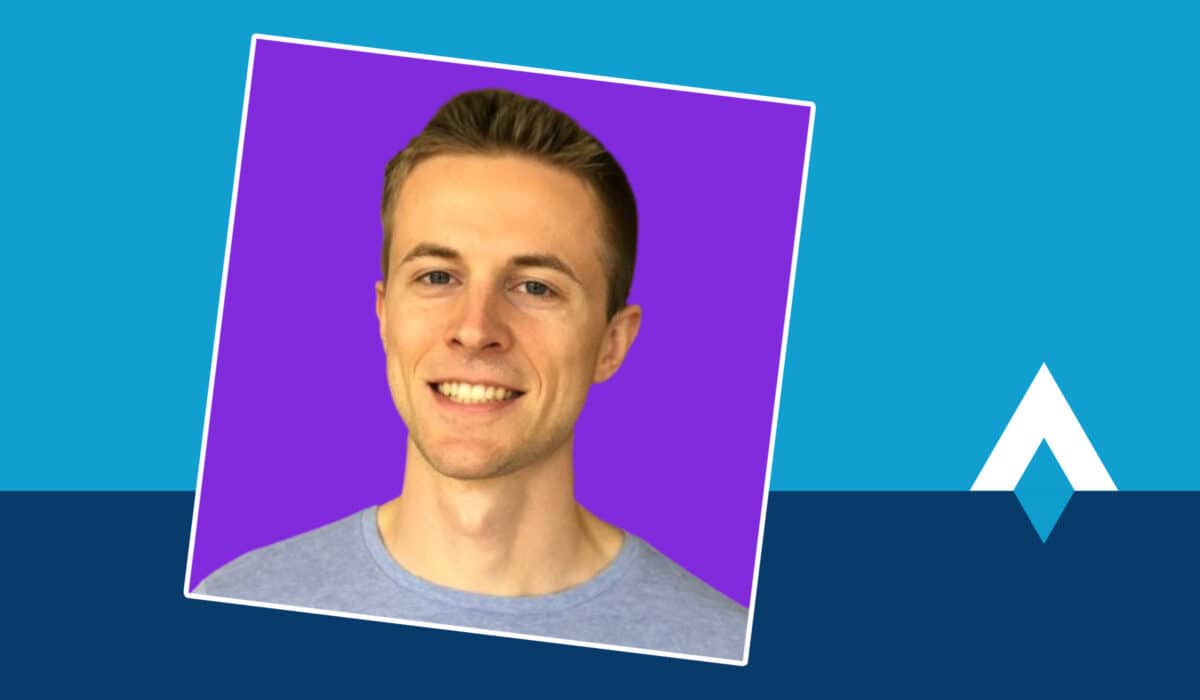 A square image of a man smiling at the camera with a purple background sits on top of a blue background with the They Got Acquired logo.